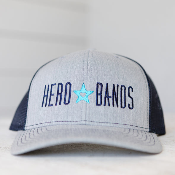 gray trucker hat embroidered with hero bands logo