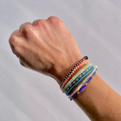 wrist with beaded survivor band bracelets